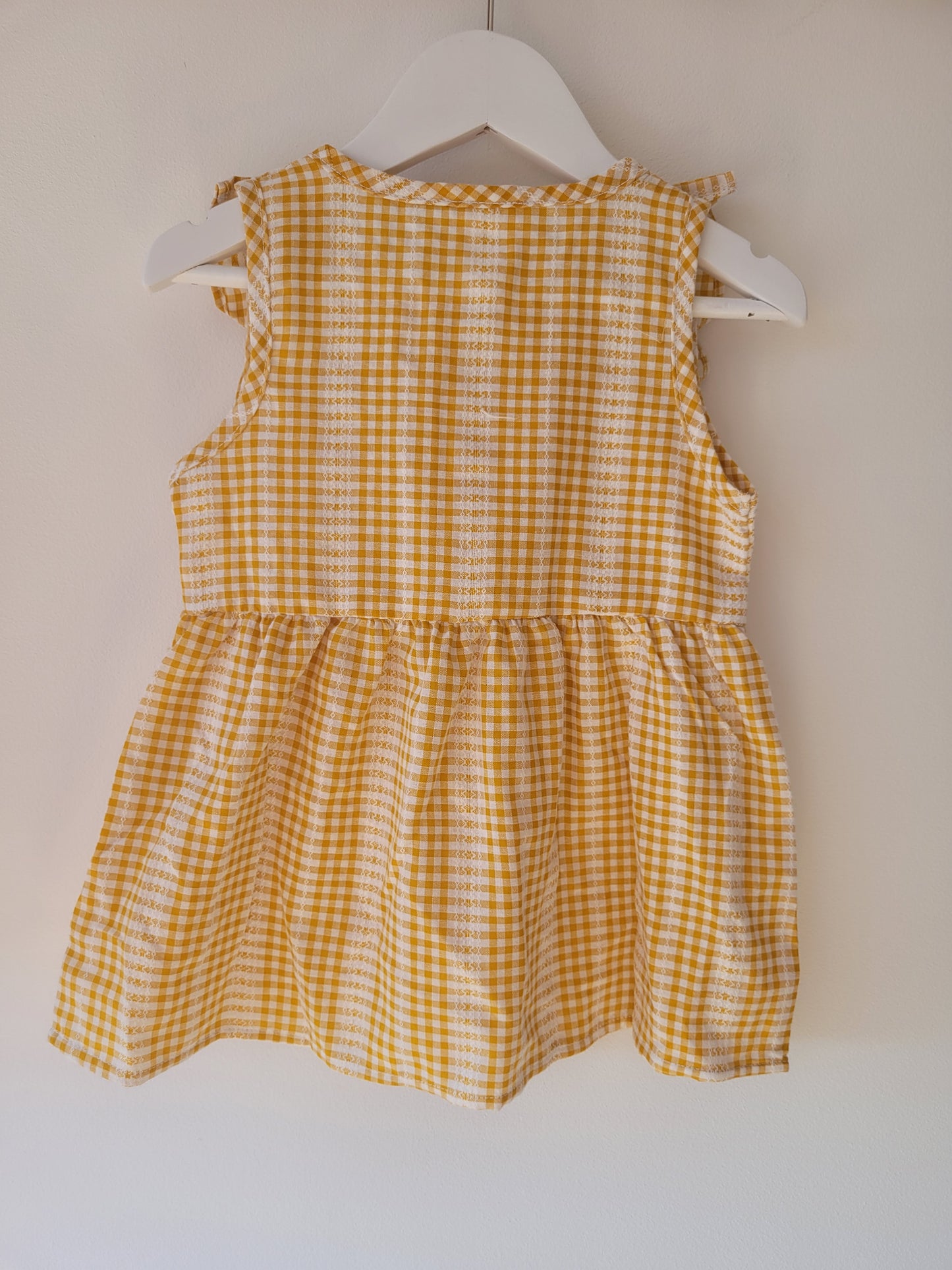 Ruffled sleeveless gingham dress in ginger