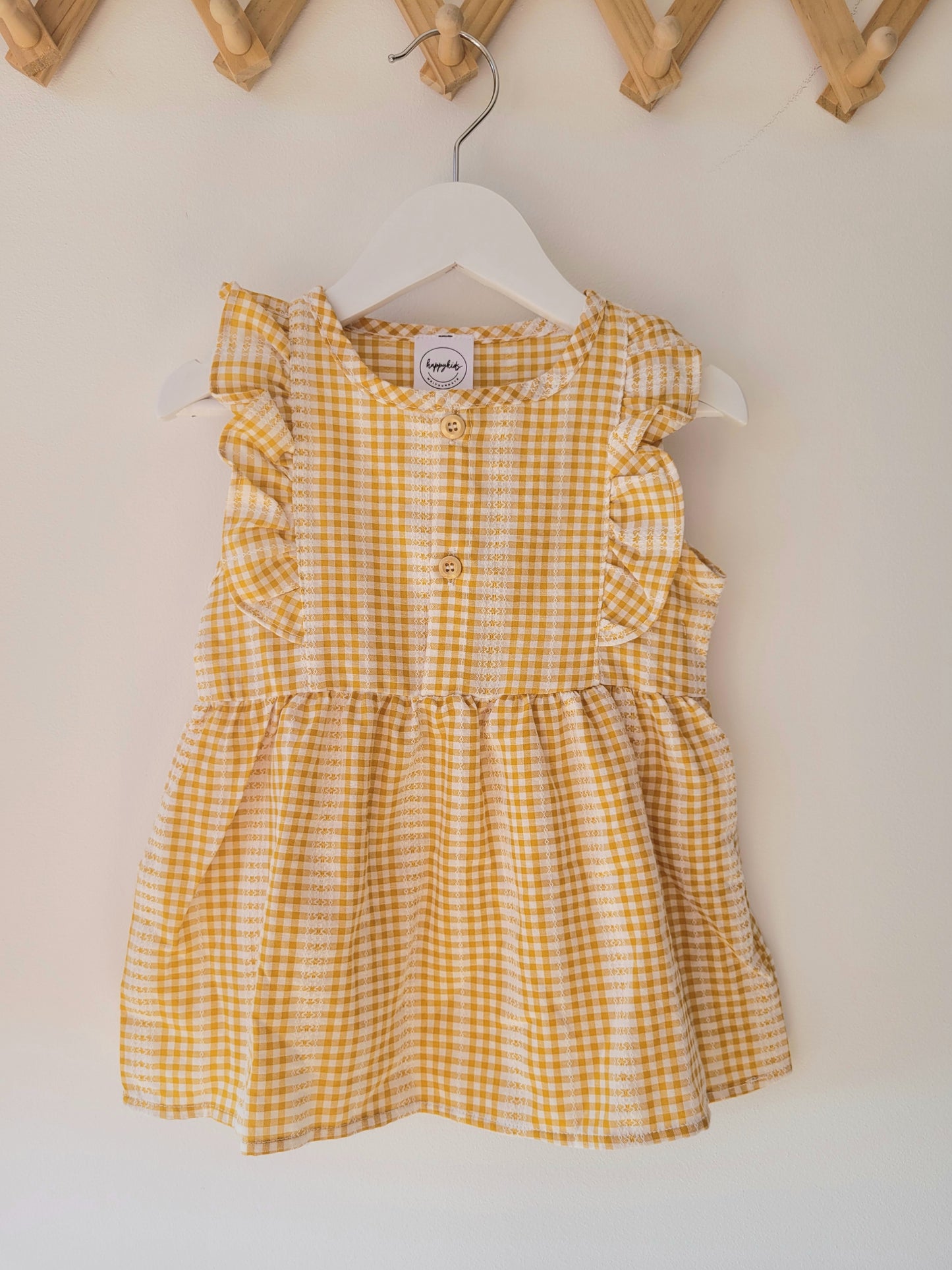 Ruffled sleeveless gingham dress in ginger