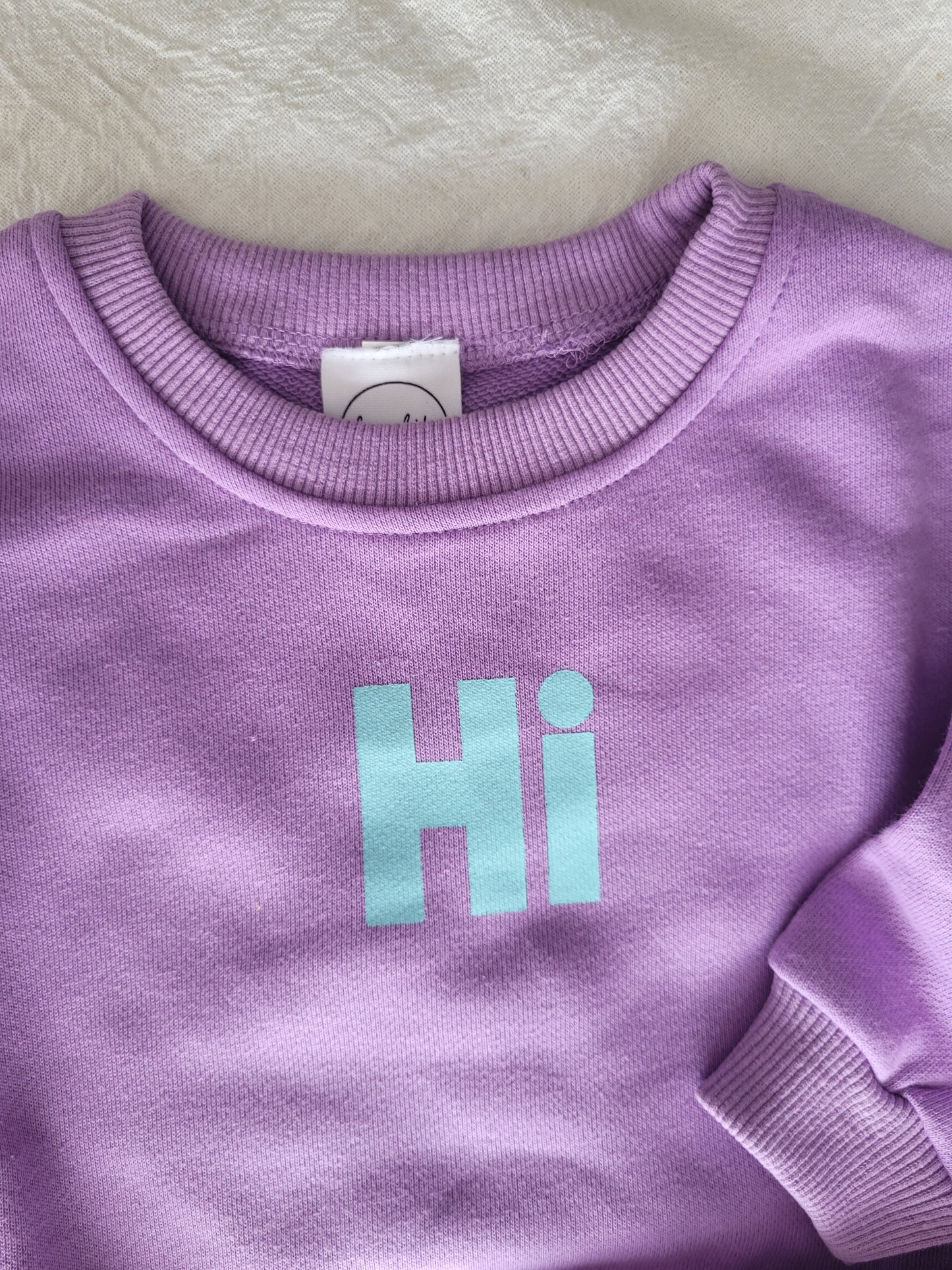 "Hi" set in purple