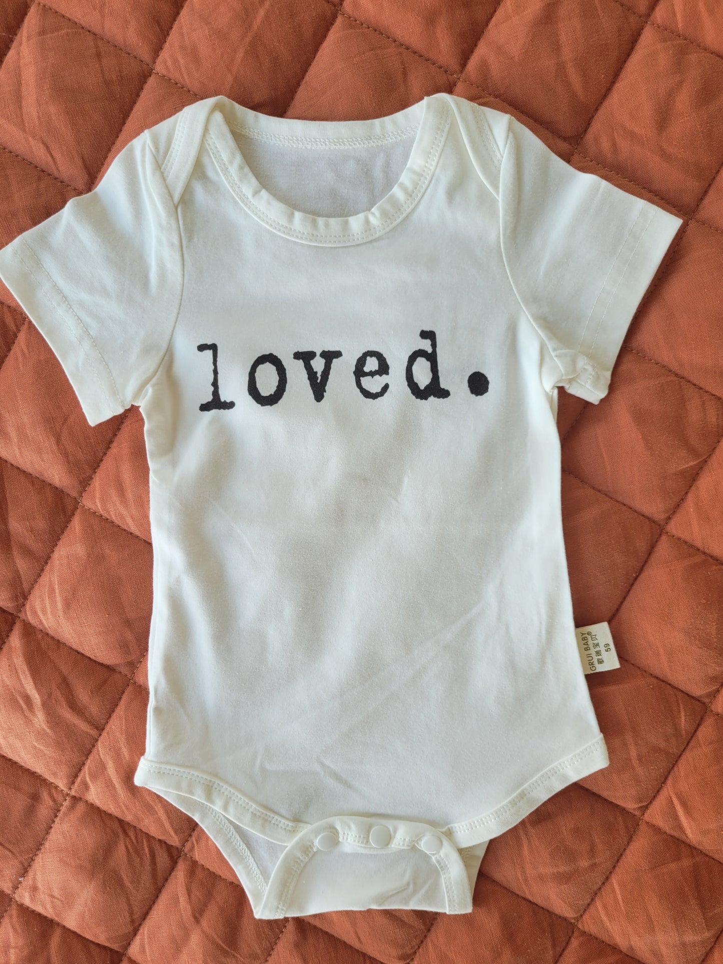 "loved" bodysuit